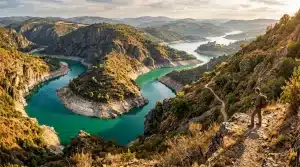 Hiker overlooking turquoise lakes nestled between rocky mountains